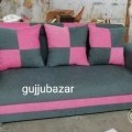 3 seater sofa with pillows near Vesu.
