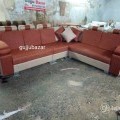 Corner sofa with pillows and puffy