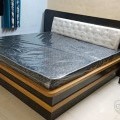wooden bed with mattress
